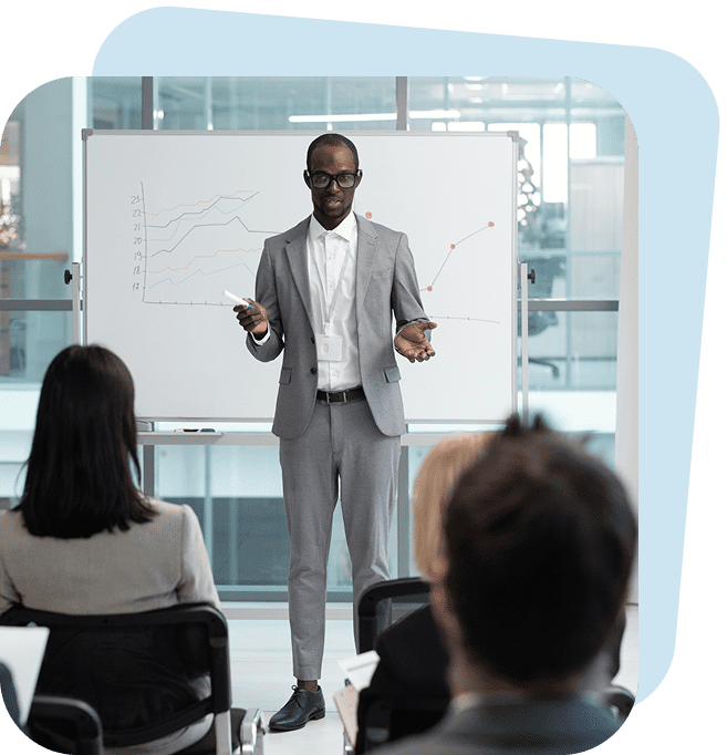 Man presenting graphs to seated audience.