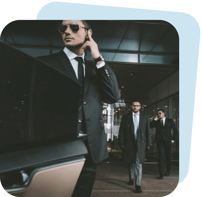 Three suited men walking confidently in an urban setting.