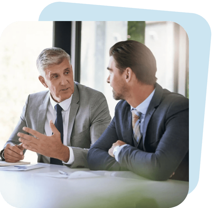 Two businessmen engaged in a serious discussion at the office.