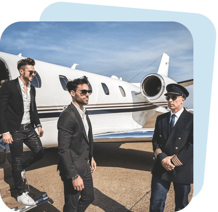 Three men in suits standing near a private jet on a sunny day.