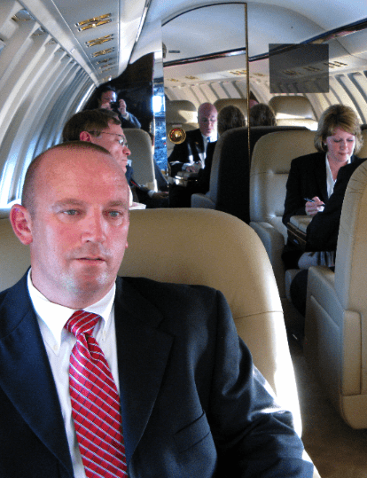 Businessman sitting in a private jet cabin.