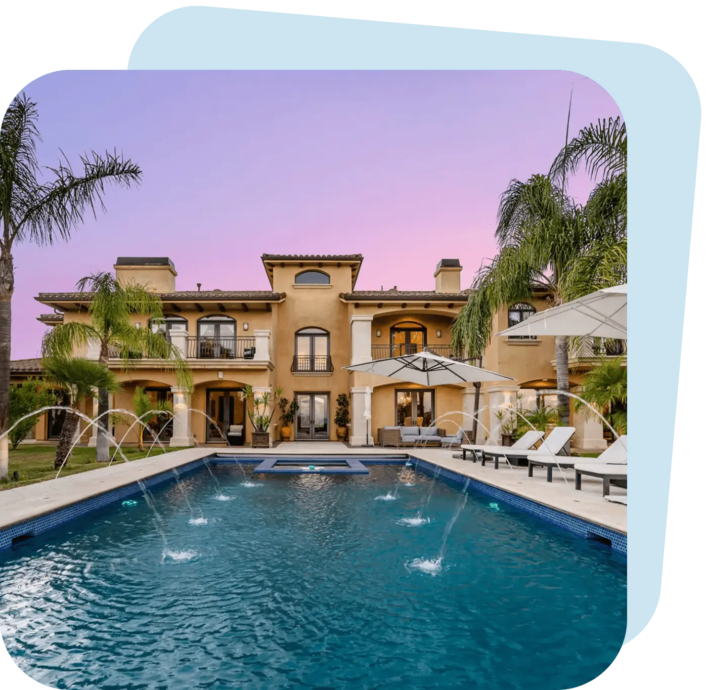 Luxury villa with a large pool and palm trees at sunset.